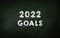 2022 Goals chalkboard. Bold Font text In green chalk Board. New Year Goals and Planning concept