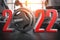2022 Happy New Year  in fitness bodybuilding workout gym. Number 2022 with barbell and oter spoirt equipment