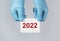 2022 new year, medical concept in hands over background