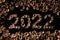 2022 new year. Numbers made from a pile of nutshells. Food style calendar. Wallpaper. Banner. Brown color walnut texture. Signed