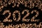 2022 new year. Numbers made from a pile of nutshells. Food style calendar. Wallpaper. Banner. Brown color walnut texture. Signed