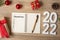 2022 Resolutions with notebook, Christmas gift and pen on wood table. Xmas, Happy New Year, Goals, To do list, start, Strategy and