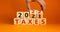 2022 taxes new year symbol. Businessman turns wooden cubes and changes words `Taxes 2021` to `Taxes 2022`. Beautiful orange