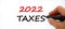 2022 taxes new year symbol. Businessman writing `2022 taxes`, isolated on white background. Business, 2022 taxes new year concep