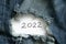 2022 written on paper that lies on torn jeans, happy new year 2022, holiday