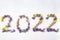 2022 written with tiny colored flowers