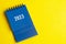 2023 blue desk calendar on yellow cover background.