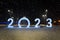 2023 figures on snow on a dark night background. Decorative figures decorate the city square for the celebration of new