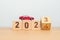 2023 flipping to 2024 year block with car model on table. Automobile Tax, Car Insurance, Financial, vehicle Repair and Maintenance