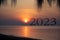 2023 Happy New Year concept, Beautiful seascape of the beach with 2023 text at sunrise