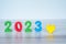 2023 standing colored block numbers on light wooden and white background with yellow heart