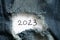 2023 written on paper that lies on torn jeans, happy new year 2023, holiday