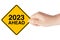 2023 Year Ahead Traffic Sign in Woman`s Hand