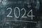 2024 date handwritten in a chalk writing text script on a wooden black chalkboard