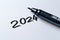 2024 date handwritten in a text script with a black marker pen on a blank white background