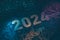 2024 digits on circuit board wire lines shine over dark background design. High technology new 2024 year greeting card concept