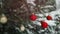 2024 Happy New Year Christmas tree decorates with red glass ball on branch snow outdoors in winter time.