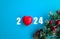 2024 new year numbers and red heart on blue background