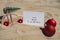 2024 SAY YES TO NEW ADVENTURES text on paper greeting card on background sandy beach sun coast. Christmas balls Santa