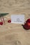 2024 SAY YES TO NEW ADVENTURES text on paper greeting card on background sandy beach sun coast. Christmas balls Santa