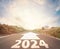 2024 target indicated by arrow on empty road. Coming into the new year, word 2024 on highway