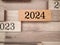 2024 text on wooden block background. New year concept.