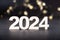 2024 wooden numbers with bokeh background. Happy new year 2024 concept