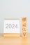 2024 Year Calendar with wood Business block, Goal, strategy, target, Resolution, mission, action, growth, teamwork, plan, idea and