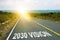 2030 vision inscription on straight road. Sunny morning landscape. Motivational inscription on the road going forward. The