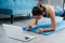 20s young Asian woman in sportswear doing plank poses while watching fitness training class on computer laptop online