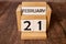 21 Februar on wooden grey cubes. Calendar cube date 21 February. Concept of date. Copy space for text or event.