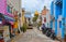 22 august 2017, small street with old colorful buildings, motorcycles and cars with chaotic traffic, old mosque with golden dome i