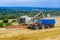 22 August 2021 Skutec, Czech Republic: The combine pours wheat into the grain truck trailer.