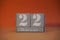 22 Februar on wooden grey cubes. Calendar cube date 22 February. Concept of date. Copy space for text. Educational cubes