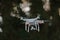 22 - Rear view of white quadcopter camera drone with gimbal underneath