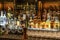 24.02.2019 Peking China - Wall with Bitters and alcohols whiskey bar counter bottles ambient tlight blurred background