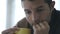 24 fps video shot hand held camera close up young man at home looking sad and drinking coffee