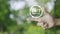 24 hours service flat icon on finger over blur green tree in park, Business full time service concept