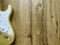 24k gold electric guitar made from a genuine alder Popular musician on veneer brown wood background with copy space