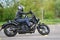 25-05-2020 Riga, Latvia. Motorcyclist goes on road, front view, closeup