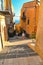 25.08.2018. View of a narrow street with young woman on steps, old buildings and facades in the historical city of Agrigento in Si