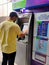 25 Aug 2020, Dhaka, Bangladesh. An asian male wearing mask using ATM machine for withdrawal of money