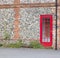 25 July 2020 - England, United Kingdom: Door of red telephone box built into wall