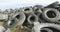 25 November 2019 - A pile of discarded tires in the open, a large landfill and pile, an environmental disaster or for recycling.
