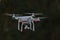 25 - Rear view of professional quadcopter camera drone hovering
