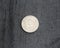 25 (twenty five) cent Netherlands Antillean guilder coin on black background