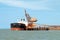 A 254 meter Ore Carrier Ship unloading Bauxite at Gladstone Harbour, Queensland, Australia