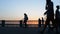 26 may 2016, Russia, Samara - city embankment. People walk, ride, bike along the river. Dark silhouettes at sunset.