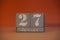 27 Januar on wooden grey cubes. Calendar cube date 27 January. Concept of date. Copy space for text. Educational cubes