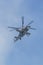 29 AUGUST 2019 MOSCOW, RUSSIA: A military gray helicopter with two pair of blades flying in the blue sky